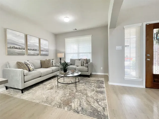 a living room with furniture and a large window