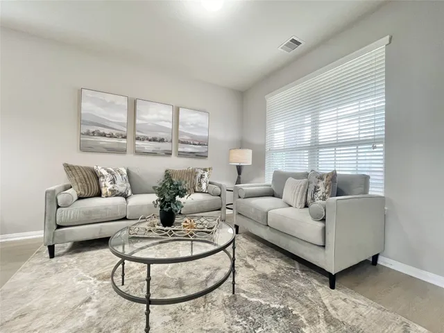 a living room with furniture and a large window