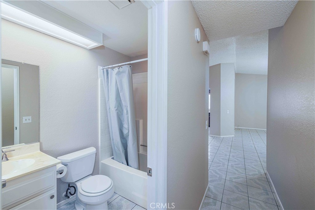 14601 Long View Drive Fontana, CA 92337 - Photo 23 of 33 a white toilet sitting next to a bathroom sink