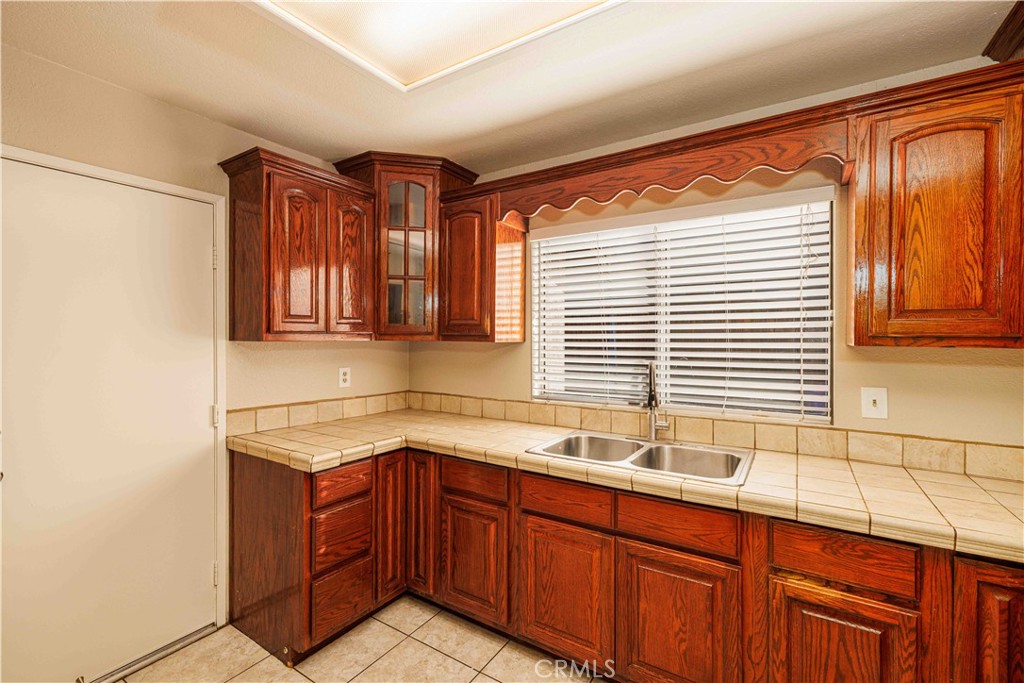 14601 Long View Drive Fontana, CA 92337 - Photo 9 of 33 a kitchen with a sink window and cabinets