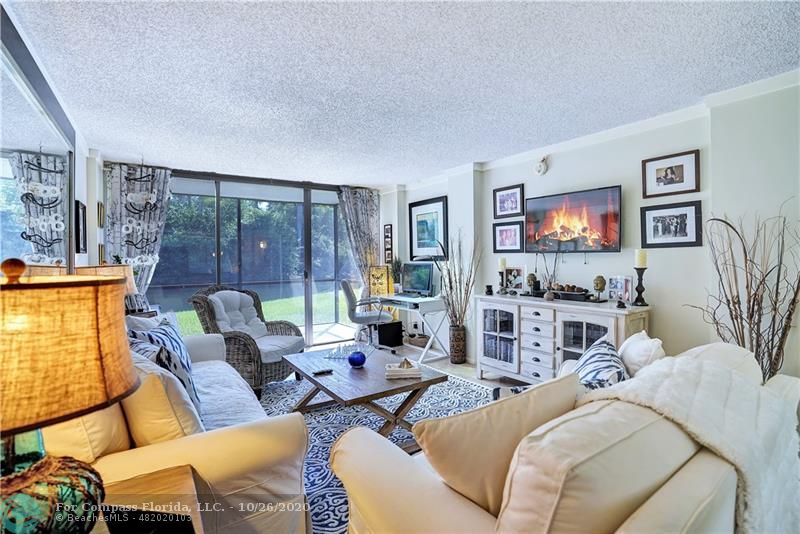 Living Room & Screened in patio overlooking the canal & Easterlin Park.