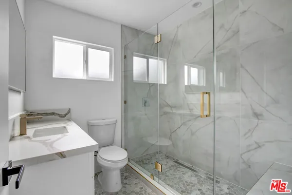 a bathroom with a sink toilet and shower