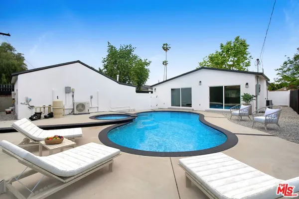 a view of house with swimming pool outdoor seating