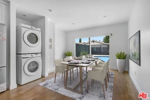 a view of a dining room with furniture and wooden floor