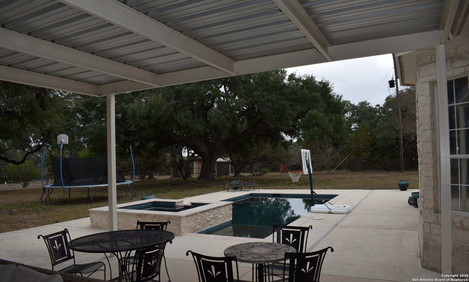 32010 Oak Ridge Parkway Bulverde, TX 78163 - Photo 14 of 48 a view of patio with table and chairs and potted plants with wooden floor