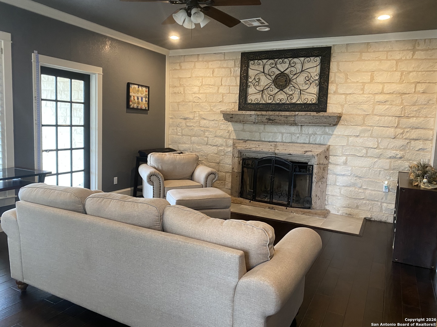 32010 Oak Ridge Parkway Bulverde, TX 78163 - Photo 16 of 48 a living room with furniture a fireplace and a flat screen tv