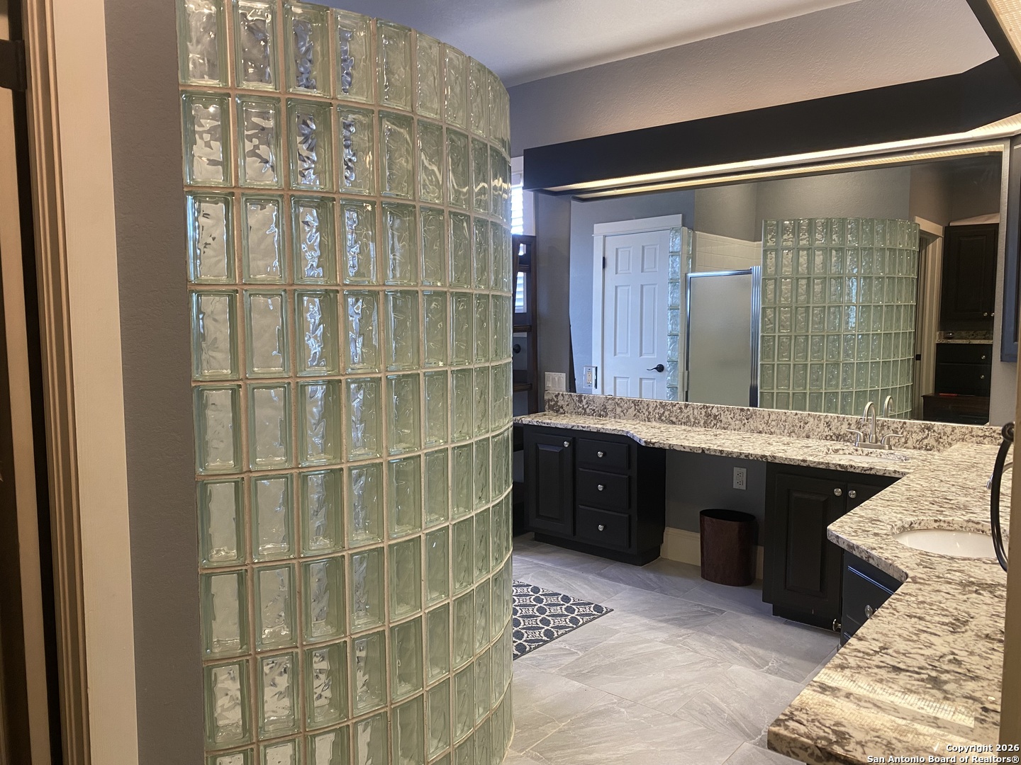 32010 Oak Ridge Parkway Bulverde, TX 78163 - Photo 28 of 48 a bathroom with a granite countertop shower and a sink