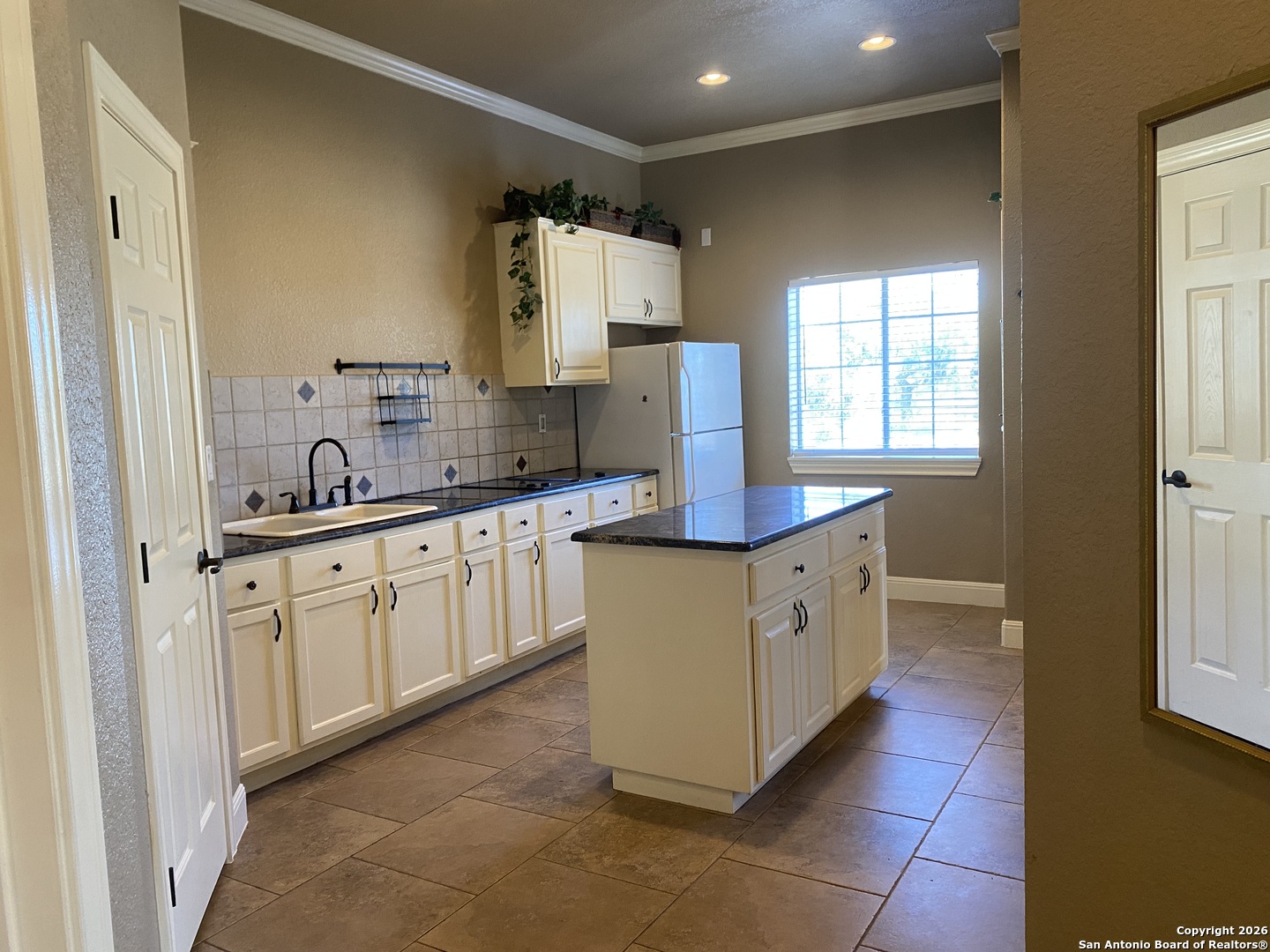 32010 Oak Ridge Parkway Bulverde, TX 78163 - Photo 41 of 48 a kitchen with cabinets appliances a sink and a window