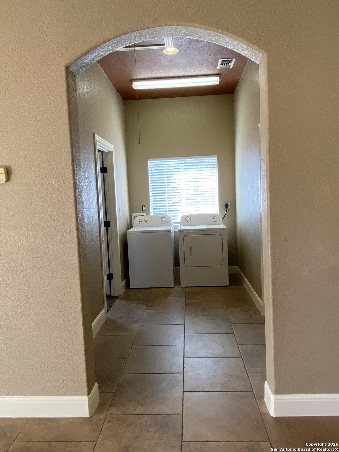 32010 Oak Ridge Parkway Bulverde, TX 78163 - Photo 44 of 48 a view of a kitchen with a sink and dishwasher a refrigerator a fireplace and a window