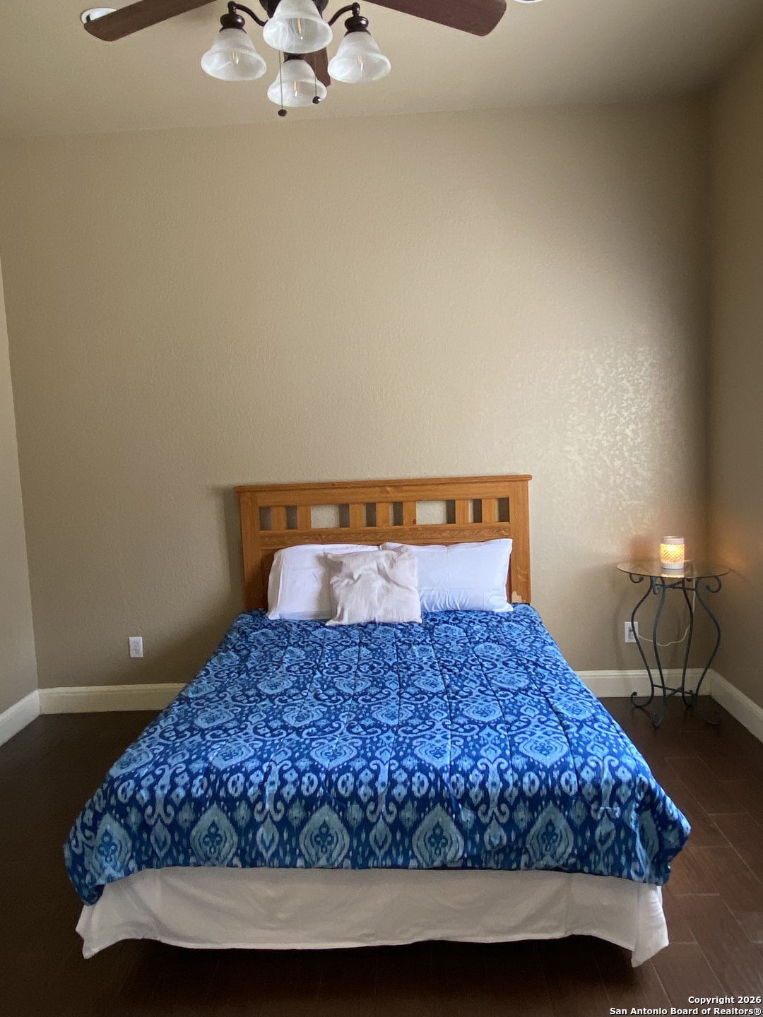 32010 Oak Ridge Parkway Bulverde, TX 78163 - Photo 45 of 48 a bedroom with a bed and chandelier
