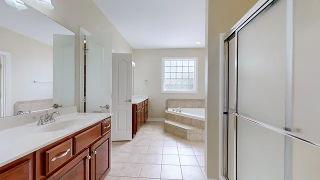 a spacious bathroom with a granite countertop sink and a mirror