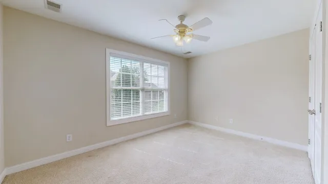 a view of house with garden space and sitting area