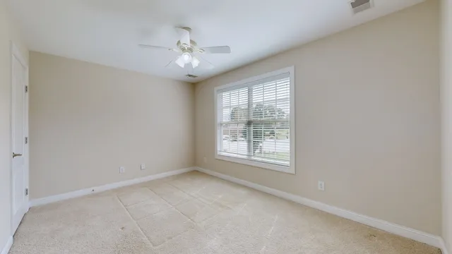a view of a field of grass and trees