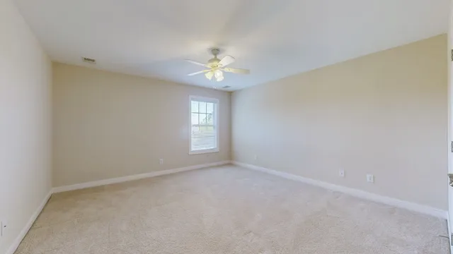 a view of a field with trees in the background