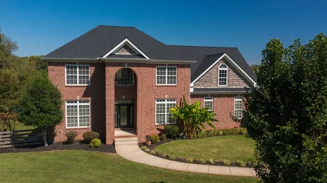 a large kitchen with stainless steel appliances granite countertop a stove a sink and a microwave