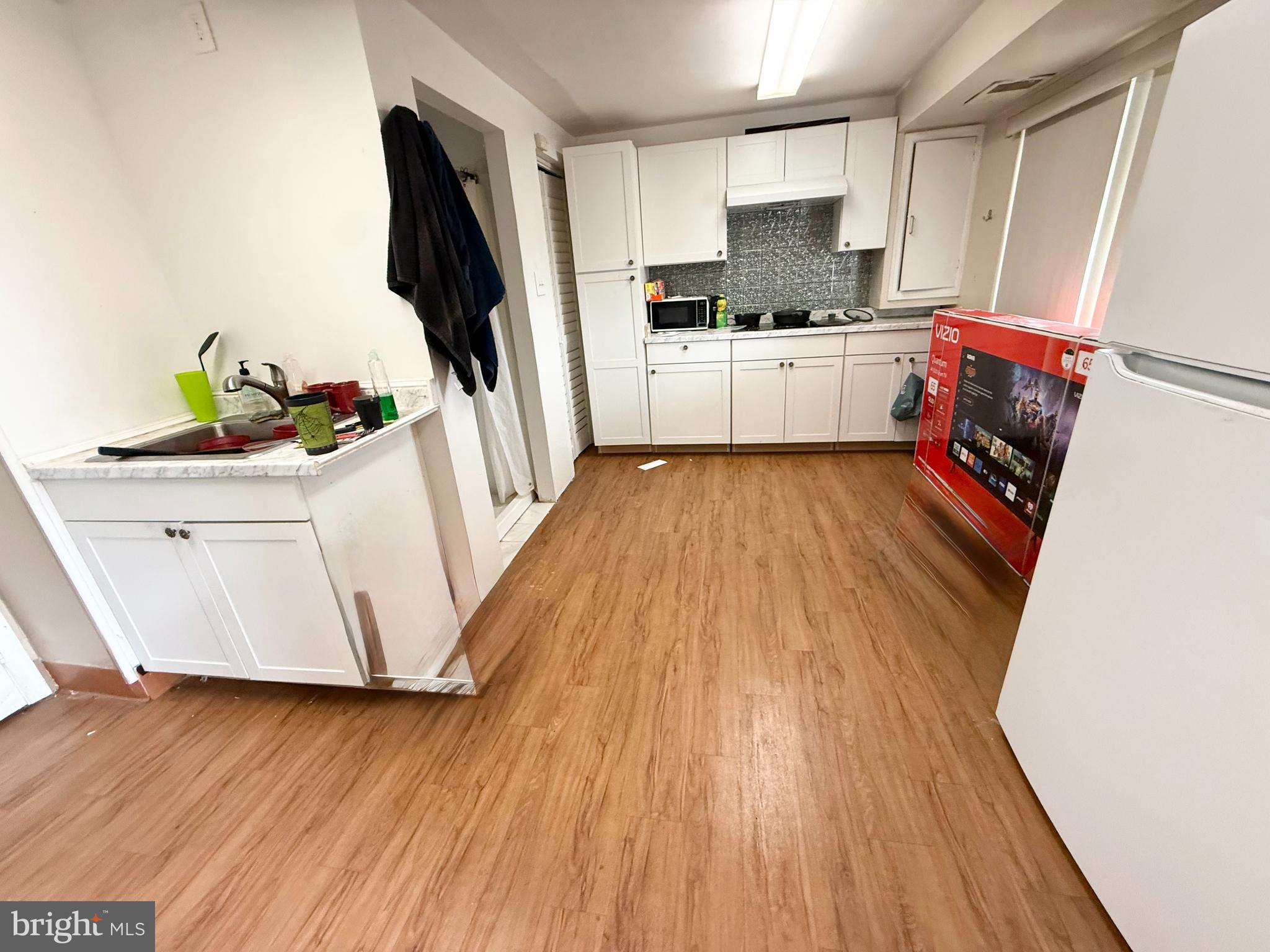 401 North Springfield Road Clifton Heights, PA 19018 - Photo 13 of 14 a kitchen with wooden floors and white stainless steel appliances