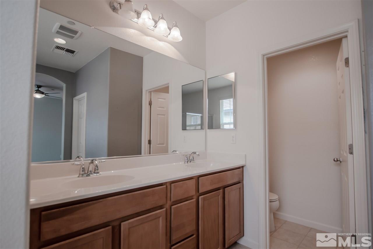 1900 Wind Ranch Road, Unit RENO Reno, NV 89521 - Photo 16 of 25 a bathroom with a double vanity sink and a mirror