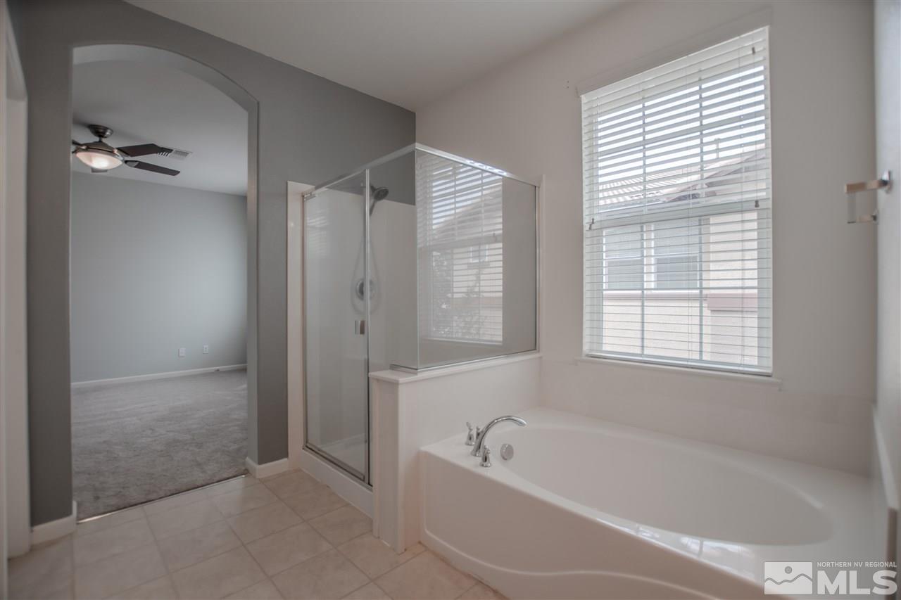 1900 Wind Ranch Road, Unit RENO Reno, NV 89521 - Photo 18 of 25 a bathroom with a bathtub and shower