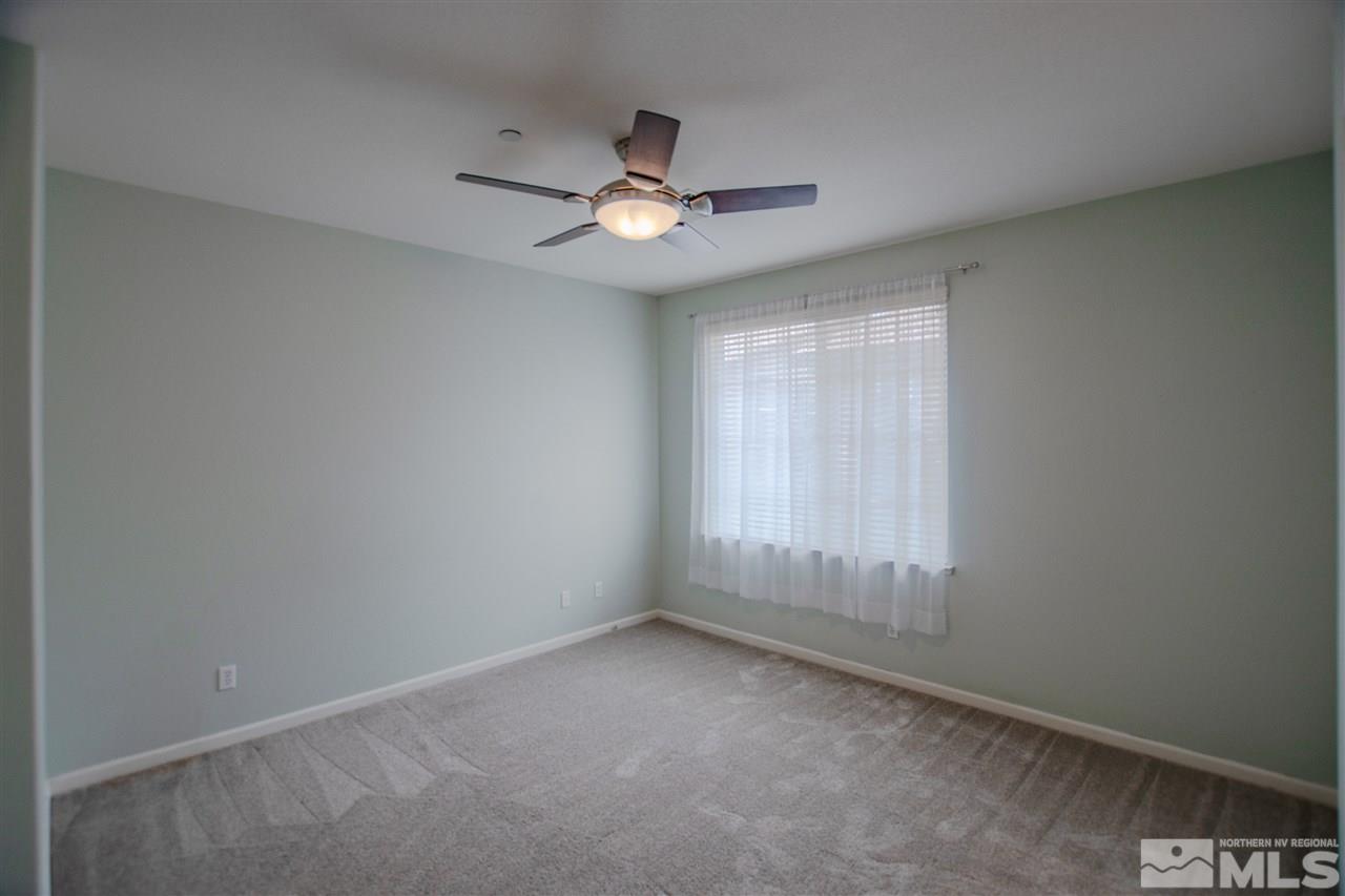 1900 Wind Ranch Road, Unit RENO Reno, NV 89521 - Photo 21 of 25 an empty room with a window and a fan