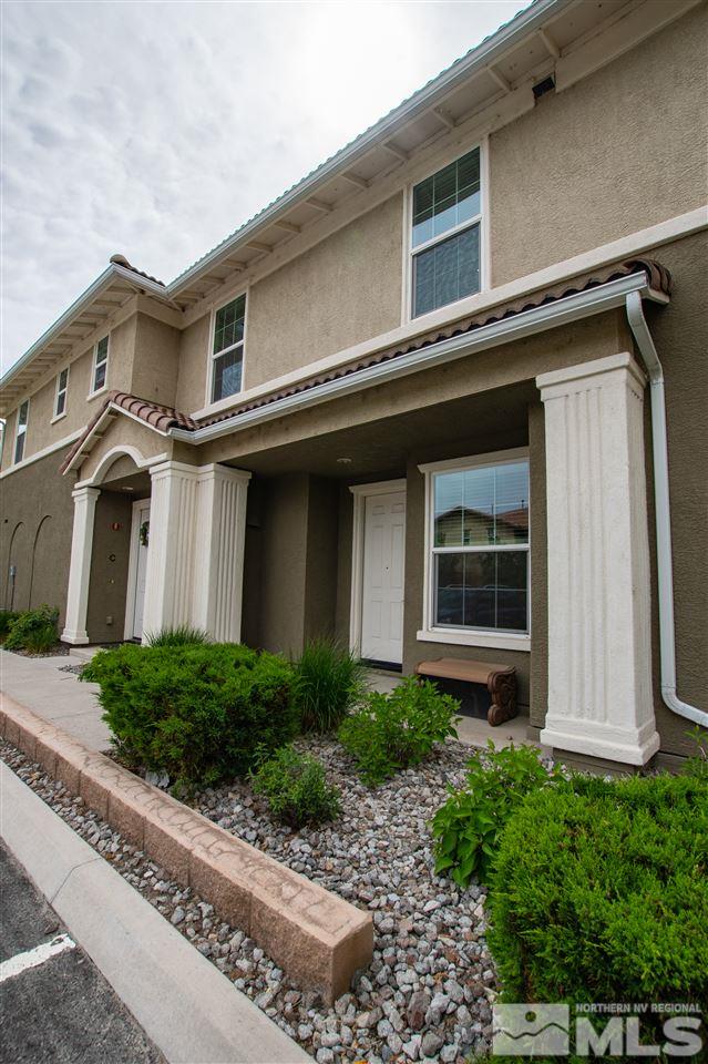 1900 Wind Ranch Road, Unit RENO Reno, NV 89521 - Photo 4 of 25 a front view of a house with a yard