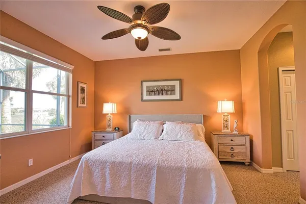 a bedroom with a large bed and a window