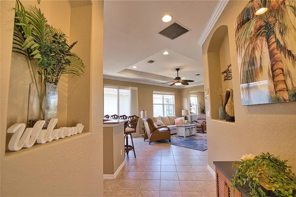 a lobby with furniture and chandelier