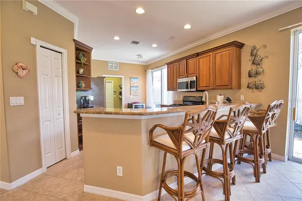 a kitchen with stainless steel appliances granite countertop a refrigerator and microwave