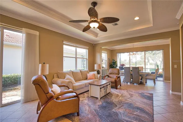 a living room with patio furniture and a large window