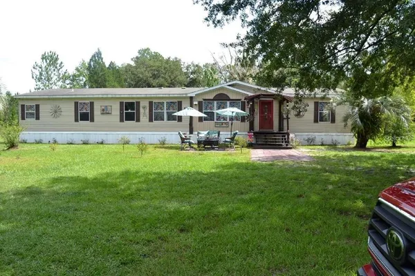 a front view of house with yard and green space