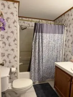a bathroom with a toilet and shower