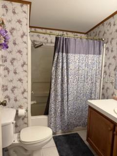 13921 Pine Meadow Road Kathleen, FL 33849 - Photo 17 of 25 a bathroom with a toilet and shower