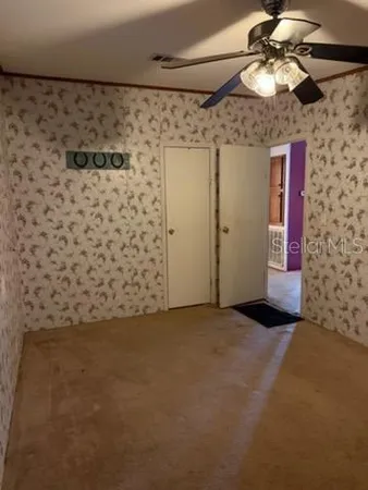 a view of a chandelier fan and closet in a room