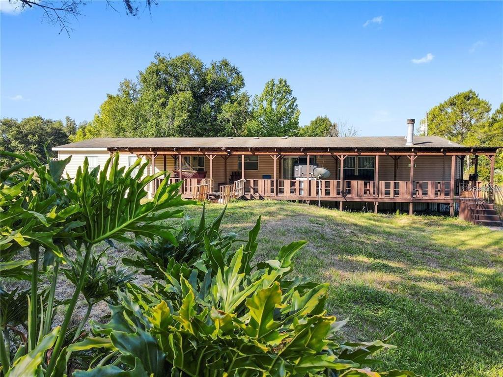 13921 Pine Meadow Road Kathleen, FL 33849 - Photo 3 of 25 front view of a house with a yard table and chairs