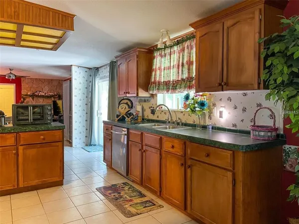 a kitchen with stainless steel appliances a sink stove and cabinets