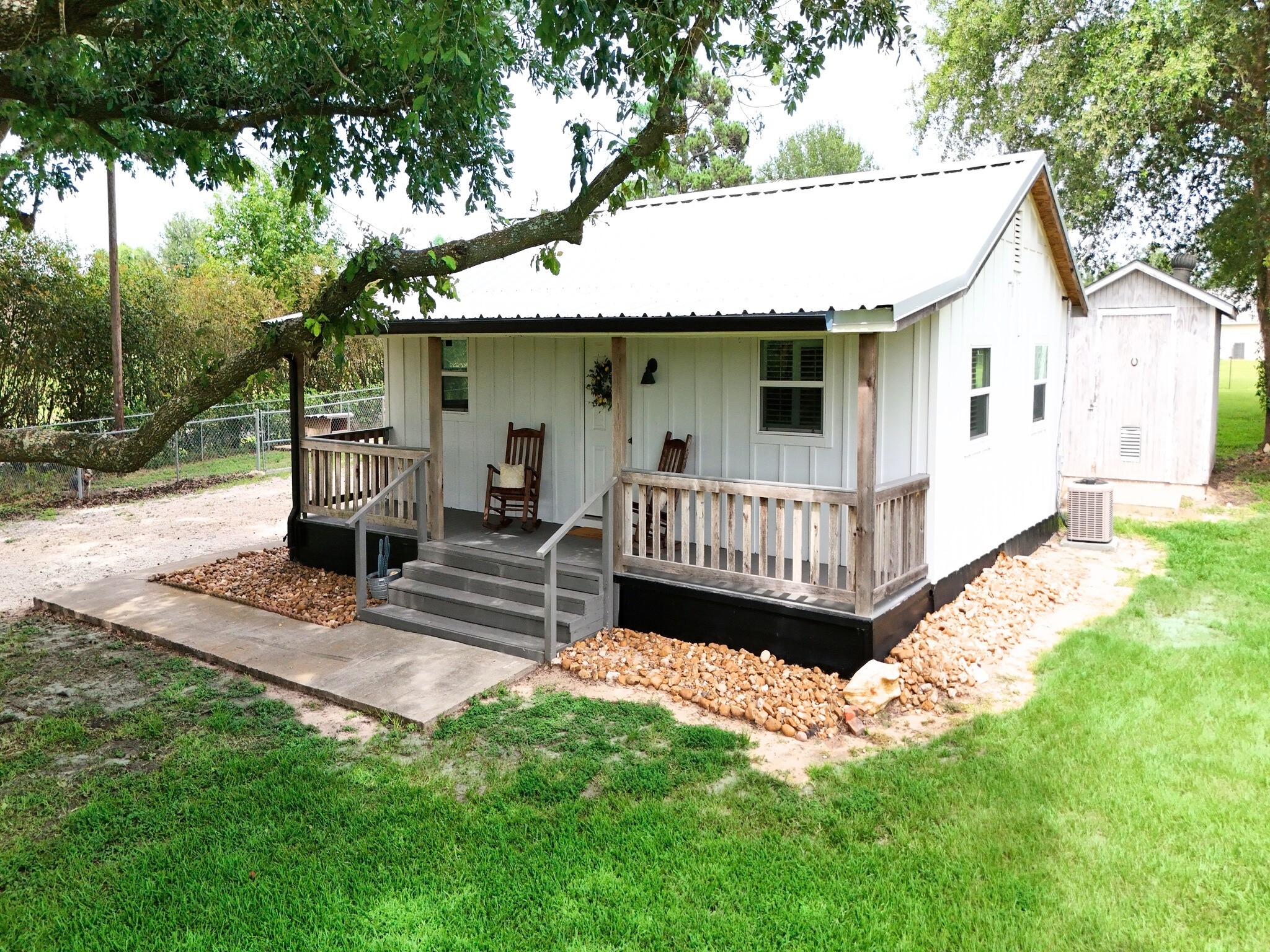 409 Moffett Springs Road Huntsville, TX 77320 - Photo 12 of 25 a view of a house with a wooden deck and a yard