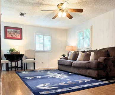 a living room with furniture a bed and a chandelier