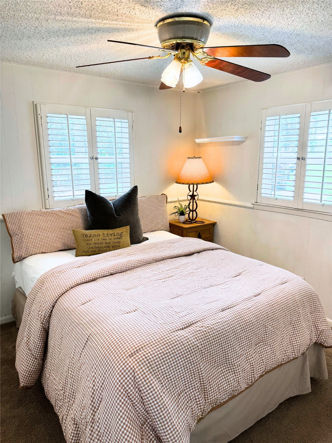 409 Moffett Springs Road Huntsville, TX 77320 - Photo 20 of 25 a bedroom with a bed and a chandelier