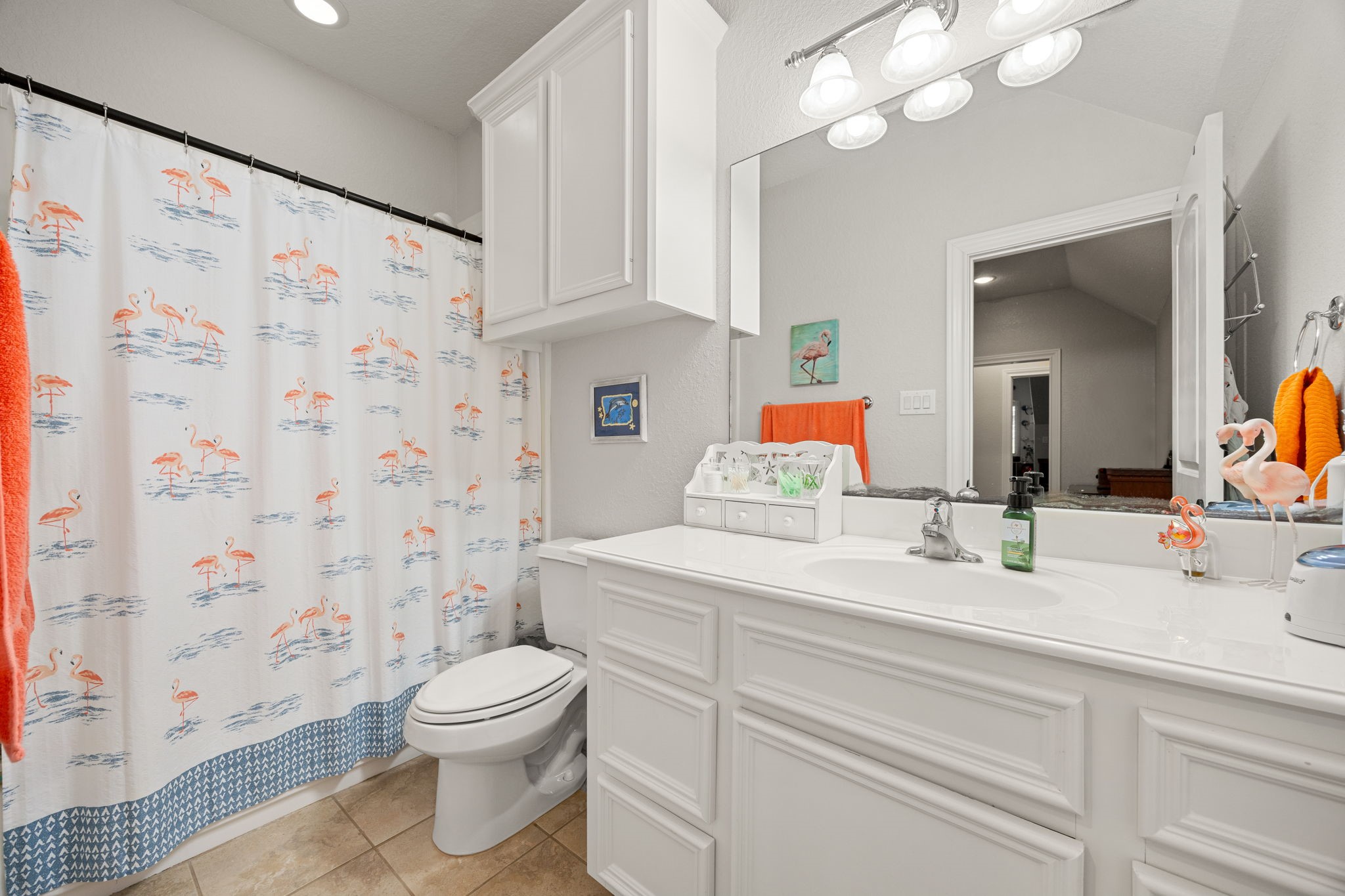 13506 Stagecoach Road Magnolia, TX 77355 - Photo 27 of 37 a bathroom with a sink a toilet and a large mirror