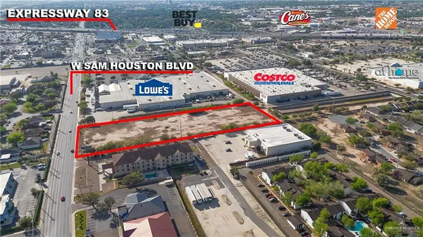 a city street filled with lots of traffic and parked cars