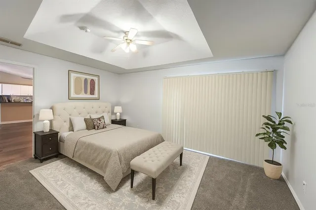 a bedroom with a bed and a potted plant