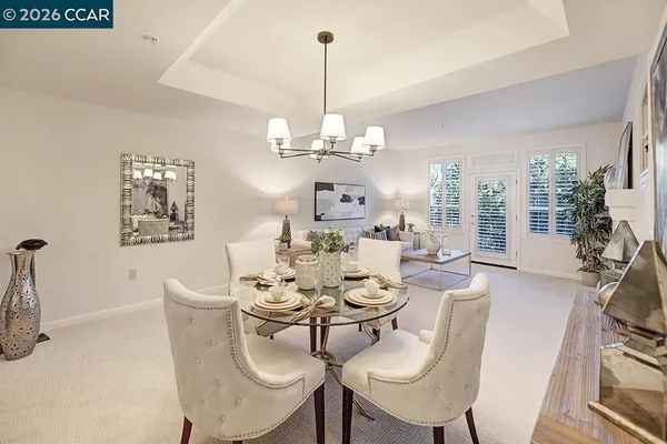 a dining room with furniture a chandelier and window