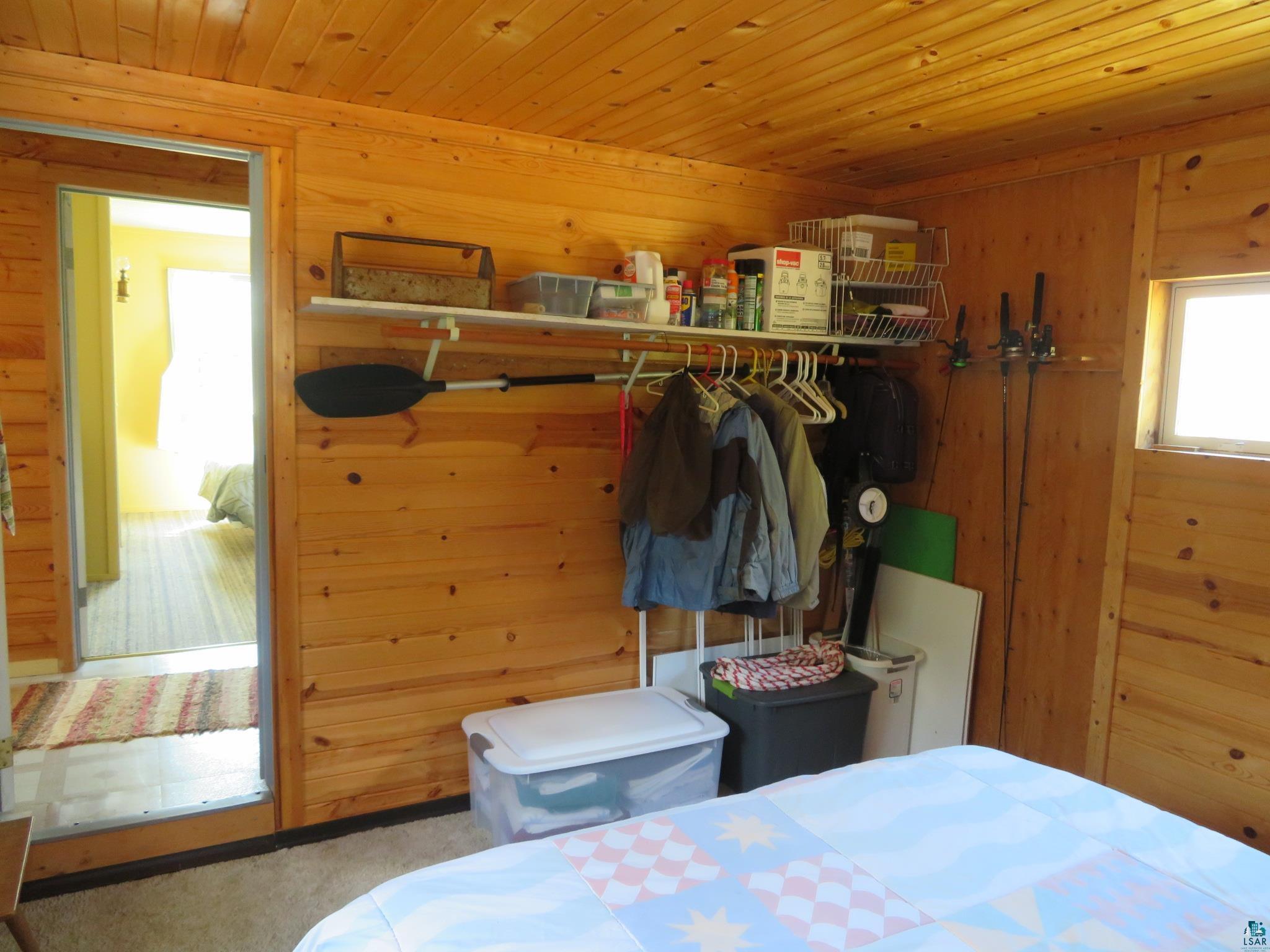 1268 Tom Lake Road Hovland, MN 55606 - Photo 20 of 56 Carpeted bedroom with wooden walls and wood ceiling