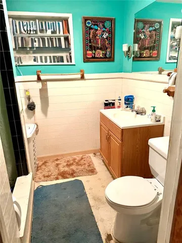 a bathroom with a toilet a sink and a shower