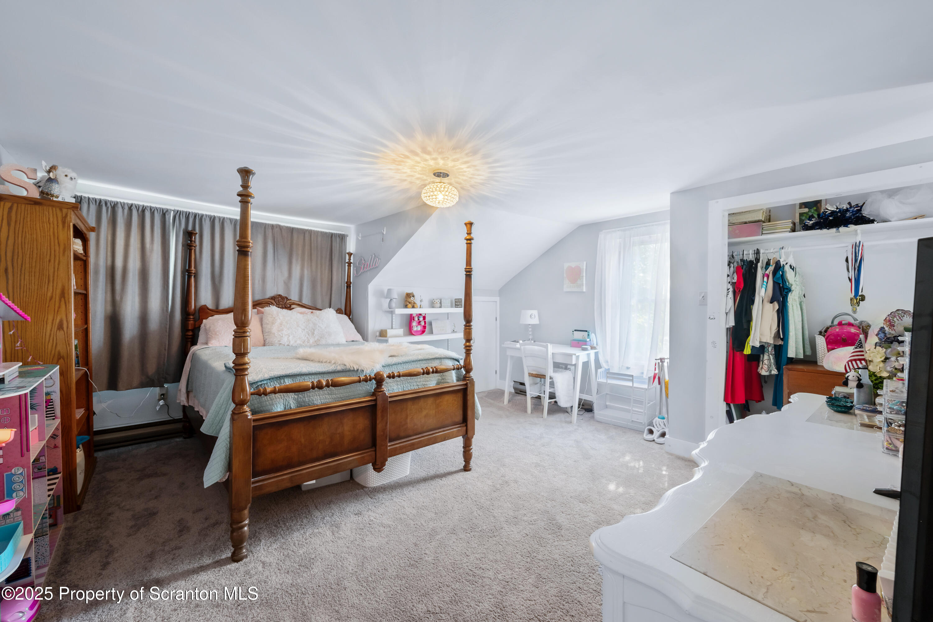 367 Carbondale Road Clarks Summit, PA 18411 - Photo 32 of 66 a bedroom with furniture and a chandelier