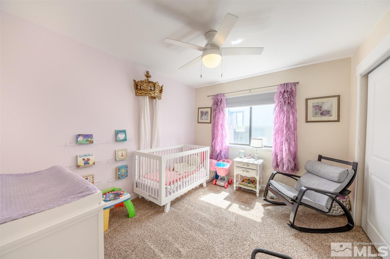 1844 Quail Run Road Reno, NV 89523 - Photo 9 of 15 a bedroom with a bed and a chandelier