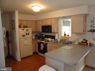 131 Sandyhook Road Ocean Pines, MD 21811 - Photo 2 of 7 a kitchen with a refrigerator stove and sink