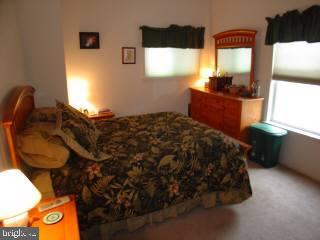 131 Sandyhook Road Ocean Pines, MD 21811 - Photo 4 of 7 a bedroom with a bed and window