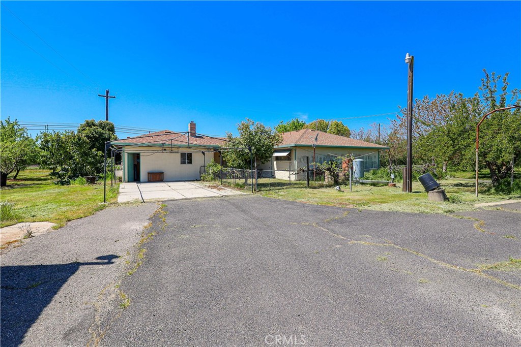 19688 Santa Fe Road Escalon, CA 95320 - Photo 13 of 13 a front view of a house with a yard and potted plants