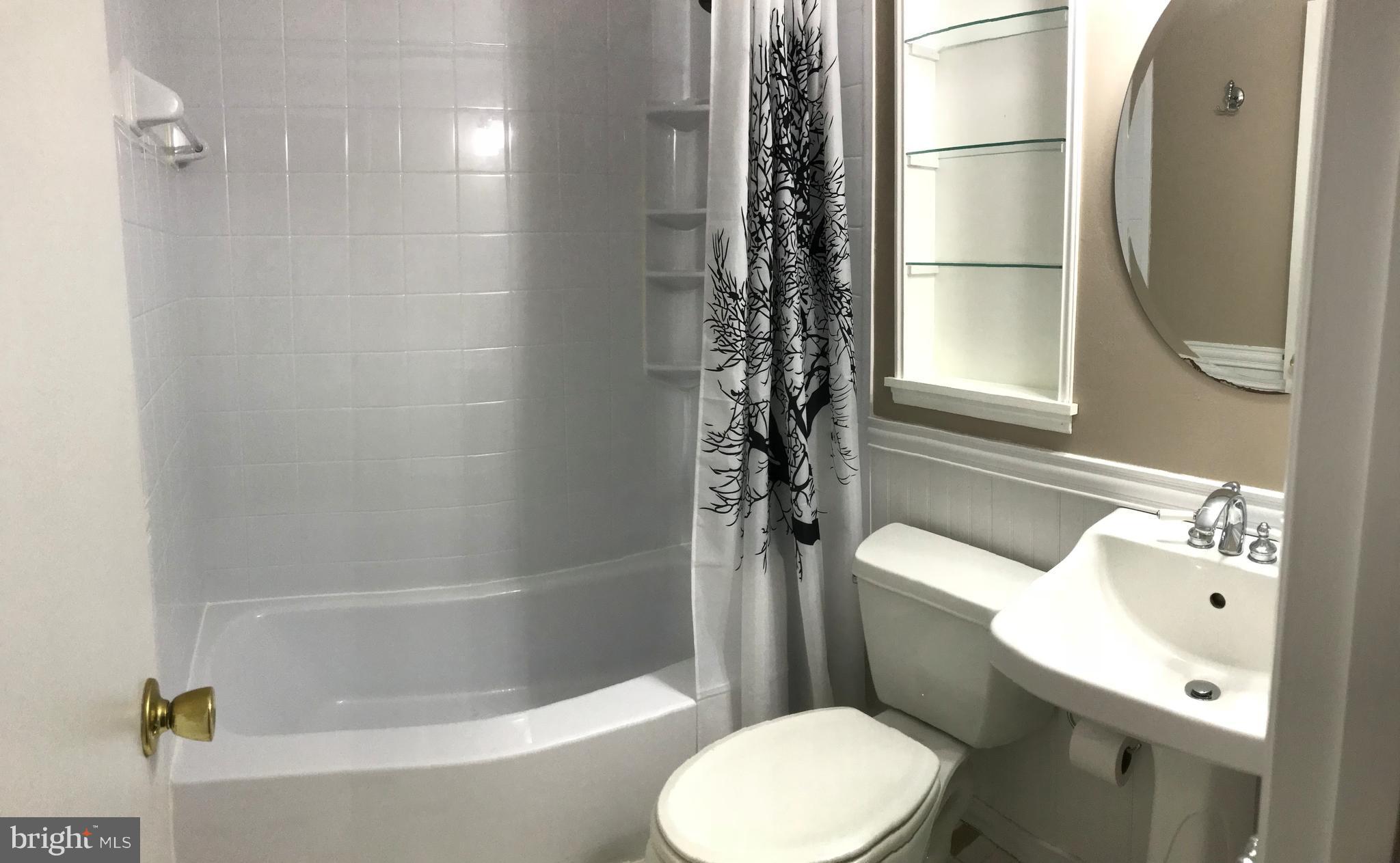 5659 Chelwynd Road Baltimore, MD 21227 - Photo 17 of 30 Full Hall Bath With Ceramic Tile and Wainscotting