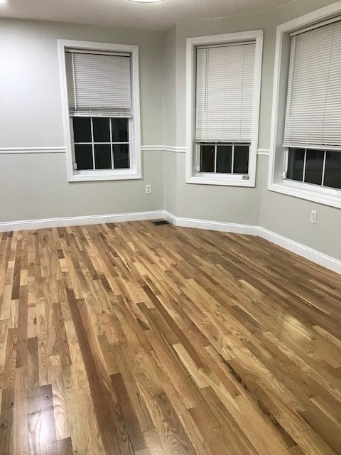 157-159 Fuller Street Boston, MA 02124 - Photo 9 of 19 a view of an empty room with wooden floor and a window